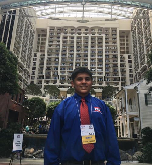 Boy standing in front of TSA building wearing the blue TSA shirt preparing to go into the competition. 